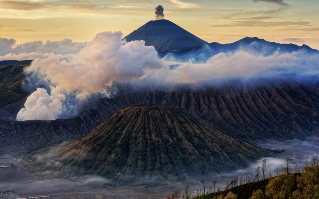 A view of a mountain covered in clouds