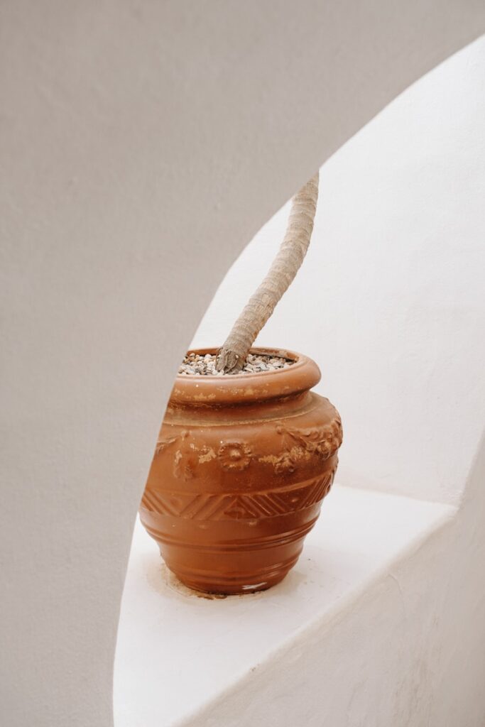 A clay pot with a rope sticking out of it